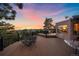 Back deck featuring a wrought iron dining table set and hot tub with sunset views at 8838 Hillview Rd, Morrison, CO 80465