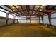 Interior of a spacious metal barn featuring lights and a billboard at 8838 Hillview Rd, Morrison, CO 80465