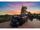 Relax in this luxurious hot tub while enjoying breathtaking mountain views at sunset from the outdoor patio deck at 8838 Hillview Rd, Morrison, CO 80465