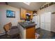 Cozy kitchen featuring an island with sink, wooden cabinets, and modern appliances at 8838 Hillview Rd, Morrison, CO 80465