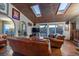Bright living room with stone tile floors, skylights, and comfortable leather seating at 8838 Hillview Rd, Morrison, CO 80465
