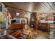 Open-concept living space with kitchen, stone fireplace, skylights, and comfortable seating at 8838 Hillview Rd, Morrison, CO 80465