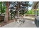 Backyard patio featuring a picnic table surrounded by lush greenery and privacy fence at 2495 S Lansing Way, Aurora, CO 80014
