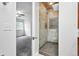 Ensuite bathroom features a glass enclosed shower with stone tile and a view into the main bedroom at 2495 S Lansing Way, Aurora, CO 80014