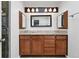 Bathroom with double vanity, granite countertops, decorative mirrors and upgraded lighting at 2495 S Lansing Way, Aurora, CO 80014