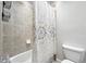 Bathroom with a modern shower curtain, tiled walls, and updated fixtures at 2495 S Lansing Way, Aurora, CO 80014