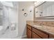 Bright bathroom featuring a granite countertop, tiled backsplash, and framed mirror at 2495 S Lansing Way, Aurora, CO 80014