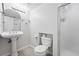 Clean bathroom features a pedestal sink, updated lighting, and a glass-enclosed shower at 2495 S Lansing Way, Aurora, CO 80014