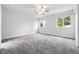 A bright, neutral bedroom features wall to wall carpet and two windows bringing in plenty of natural light at 2495 S Lansing Way, Aurora, CO 80014