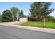 Charming single-Gathering home featuring a manicured lawn, brick accents, and an attached two-car garage at 2495 S Lansing Way, Aurora, CO 80014
