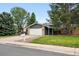 Charming single-Gathering home featuring a manicured lawn, brick accents, and an attached two-car garage at 2495 S Lansing Way, Aurora, CO 80014