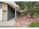 Inviting home entrance with a flagstone walkway leading to the front door and mature landscaping at 2495 S Lansing Way, Aurora, CO 80014