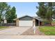 Charming single-story home with a brick exterior, a two-car garage, and a well-manicured front yard at 2495 S Lansing Way, Aurora, CO 80014