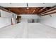 Clean, spacious garage with ample storage cabinets, a workbench, and plenty of open space for vehicles at 2495 S Lansing Way, Aurora, CO 80014