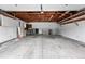 Large, unfinished garage with exposed ceiling beams and concrete floor at 2495 S Lansing Way, Aurora, CO 80014