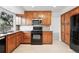 Modern kitchen featuring granite countertops, stainless steel appliances, and ample cabinet space at 2495 S Lansing Way, Aurora, CO 80014