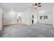 Spacious living room with vaulted ceilings, plush carpet, and access to the staircase and kitchen at 2495 S Lansing Way, Aurora, CO 80014