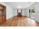 Spacious living area with hardwood floors, a brick fireplace, and sliding glass doors leading to the backyard at 2495 S Lansing Way, Aurora, CO 80014