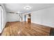 Bright, open living area features gleaming hardwood floors and access to the staircase and adjacent spaces at 2495 S Lansing Way, Aurora, CO 80014