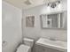 Updated bathroom features a new vanity, toilet, and decorative mirror with artwork at 5428 W 115Th Dr, Westminster, CO 80020