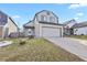 Two-story house with gray siding, attached garage, and small front yard at 5428 W 115Th Dr, Westminster, CO 80020