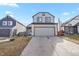 Two-story house with gray siding, attached garage, and small front yard at 5428 W 115Th Dr, Westminster, CO 80020