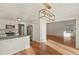 Bright kitchen and dining area featuring hardwood floors and modern appliances at 5428 W 115Th Dr, Westminster, CO 80020