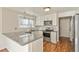 Modern kitchen with stainless steel appliances, granite countertops, and white cabinets at 5428 W 115Th Dr, Westminster, CO 80020