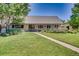 Beautiful single-story home with lush green lawn and inviting walkway at 3631 E Virginia Ave, Denver, CO 80209