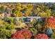 Stunning aerial view of the property surrounded by vibrant fall foliage and mature trees at 9 Sedgwick Dr, Englewood, CO 80113