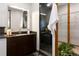 Modern bathroom with a dark granite vanity and an enclosed shower at 9 Sedgwick Dr, Englewood, CO 80113