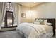 Cozy bedroom with a large window, plush bedding, and a decorative chandelier at 9 Sedgwick Dr, Englewood, CO 80113