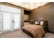 Inviting bedroom boasts a bed with storage, shuttered french doors, and unique overhead lighting at 9 Sedgwick Dr, Englewood, CO 80113