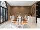 Elegant dining room featuring modern chairs with orange accents and ample seating for Gathering and guests at 9 Sedgwick Dr, Englewood, CO 80113