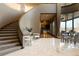 Grand foyer showcasing a curved staircase, marble floors, and an open layout, creating a luxurious and inviting entrance at 9 Sedgwick Dr, Englewood, CO 80113