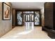 Grand foyer with a large tile floor, decorative glass doors, and textured walls at 9 Sedgwick Dr, Englewood, CO 80113
