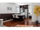 Modern kitchen featuring stainless steel appliances, an island with bar seating, and hardwood floors at 9 Sedgwick Dr, Englewood, CO 80113