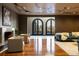 Beautiful living room with modern furnishings, a fireplace, and views of the outdoors through arched windows at 9 Sedgwick Dr, Englewood, CO 80113