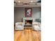 Cozy seating area with a fireplace, modern art, and warm hardwood floors at 9 Sedgwick Dr, Englewood, CO 80113