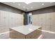 Spacious walk-in closet with custom cabinetry, a large center island, and recessed lighting at 9 Sedgwick Dr, Englewood, CO 80113