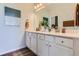 Bright bathroom featuring double sinks, modern vanity, stylish decor, and hardwood floors at 14151 Deertrack Ln, Parker, CO 80134