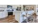 Well-equipped kitchen featuring white cabinets, stainless steel appliances, and a center island with seating at 14151 Deertrack Ln, Parker, CO 80134