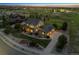 Beautiful aerial view of a two-story home with a landscaped yard and a three car garage at dusk at 5605 Killen Ave, Castle Rock, CO 80104