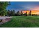 Expansive backyard with lush green lawn, mature trees, and a patio, perfect for outdoor entertaining at 5605 Killen Ave, Castle Rock, CO 80104