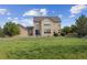 Tan two story home with walk out basement in a grassy backyard at 5605 Killen Ave, Castle Rock, CO 80104