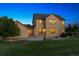 Two-story home with a well-maintained lawn, concrete patio, and mature trees providing shade and privacy at 5605 Killen Ave, Castle Rock, CO 80104