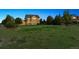 Two-story home with a large lawn area and mature trees providing shade and privacy at 5605 Killen Ave, Castle Rock, CO 80104