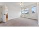 Spacious bedroom featuring neutral carpet, white walls and trim, and large windows for natural light at 5605 Killen Ave, Castle Rock, CO 80104