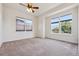 Spacious bedroom featuring neutral carpet, white walls and trim, and large windows for natural light at 5605 Killen Ave, Castle Rock, CO 80104