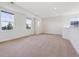 Bright bonus room featuring neutral carpet, white trim, and windows allowing an abundance of natural light at 5605 Killen Ave, Castle Rock, CO 80104